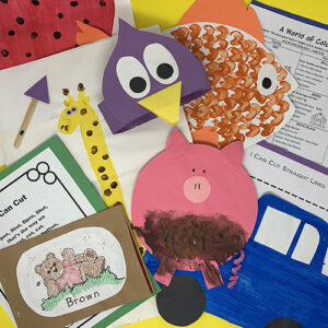 World of color projects compiled into a group, including a painted "muddy" pig, a goldfish, a penguin hat, and various worksheets